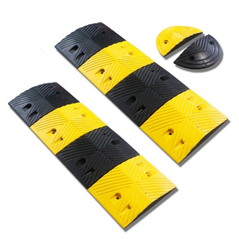 Black and yellow rubber speed bumps. Traffic calming devices for roads and parking lots. Safety equipment to reduce vehicle speed.