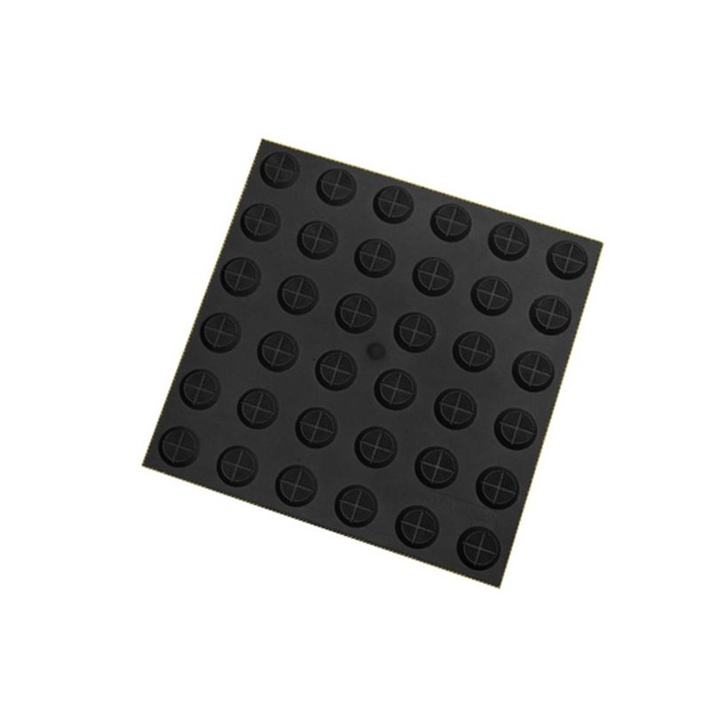 Tactile paving tile. Black square tile with raised tactile indicators for visually impaired pedestrians. Safety flooring with tactile surface.