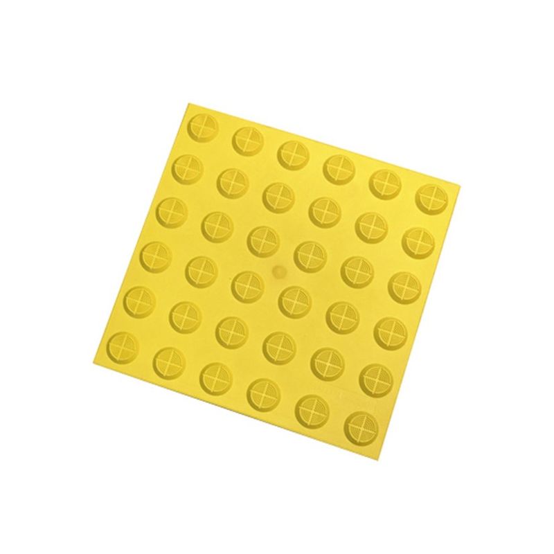Yellow tactile paving tile. Detectable warning surface with truncated domes. Safety flooring for visually impaired pedestrians.