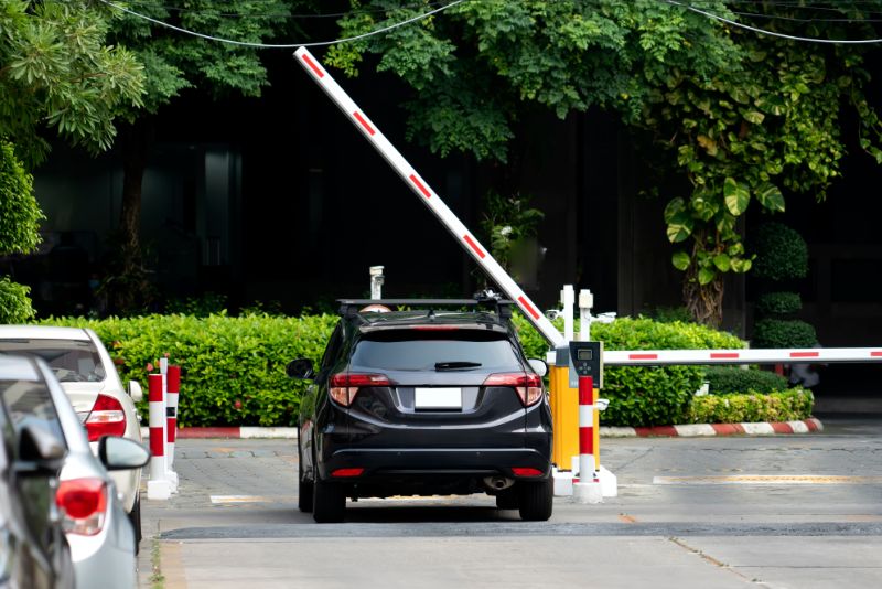 Automatic Boom Gates How Do Boom Gates Work? 1 Boom gate operation: A car waits as the boom gate arm is raised. Illustrates how boom gates work in controlling vehicle access.