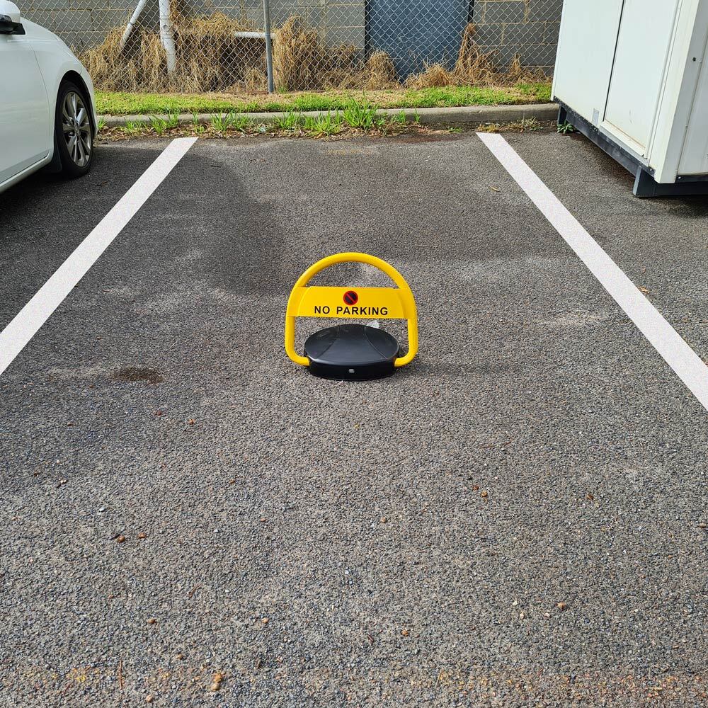 Automatic car park bollard Dugite Automatic Parking Bollard 2 Dugite automatic parking bollard in a parking space. The yellow bollard has a no parking sign. Parking management and security solution.