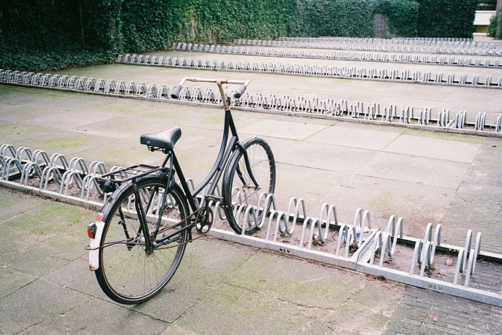 Bad Bike Racks Installing Bike Racks: A Brief Bike Parking Guide for Perth 1 Bike parked at a bike rack in Perth. Rows of empty bike parking racks suggest the need for more bike racks and parking solutions.