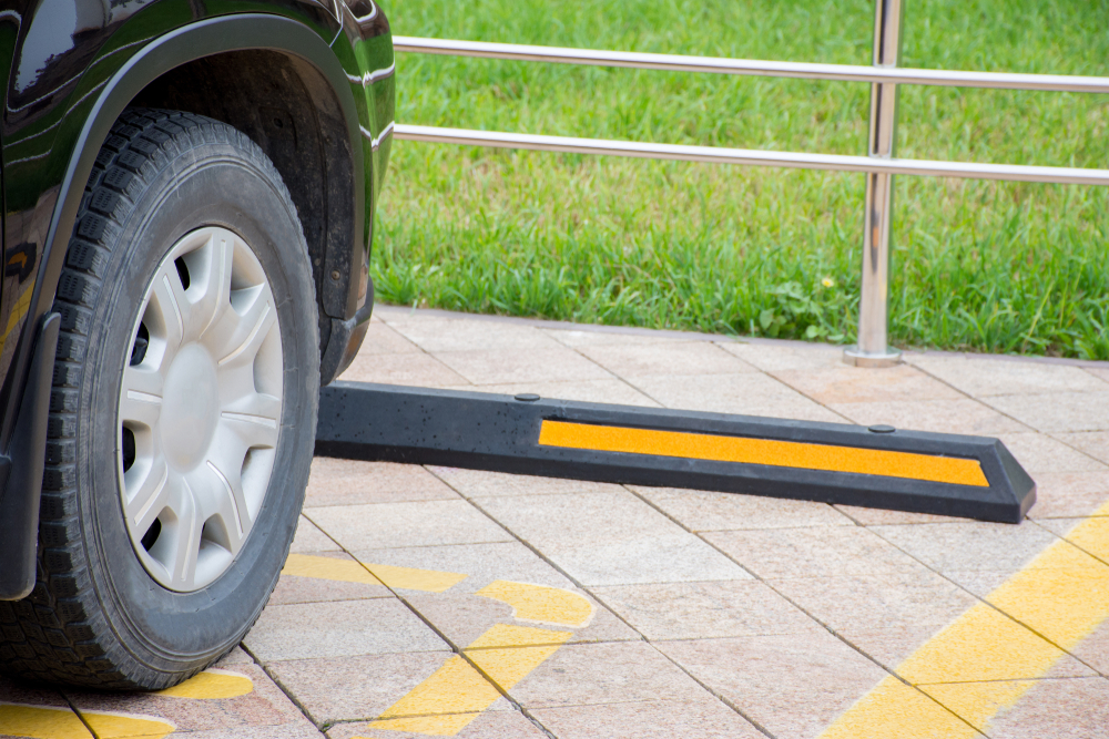 How to choose install your Rubber Wheelstops How To Choose & Install Your Rubber Wheel Stops 1 Close-up of a car wheel against a rubber wheel stop. The wheel stop has a yellow stripe. Parking safety equipment installation.