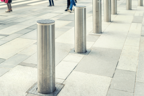 Steel Bollards What You Need To Know Steel Bollards: What You Need To Know 1 Row of steel bollards on a paved walkway. These steel bollards are safety barriers for pedestrian zones, offering robust protection.