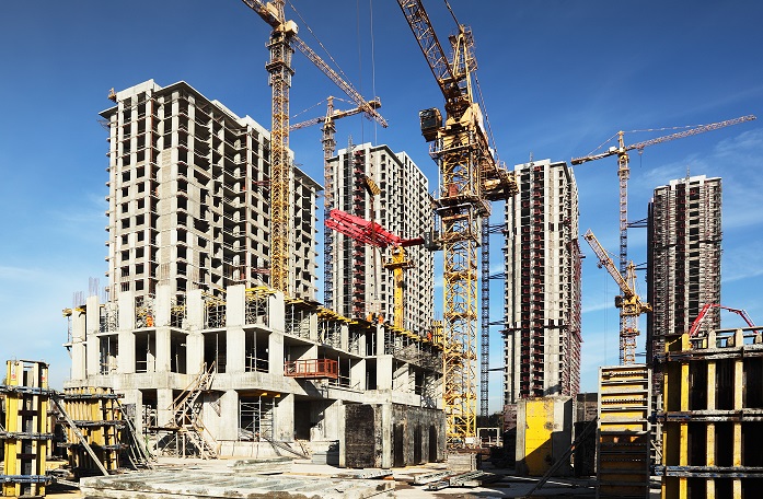 building construction Know your Disability Access Code Building Obligations 1 Building Obligations: Construction site with cranes and high-rise buildings under construction against a blue sky. Disability Access Code.