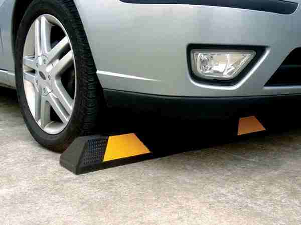 rubber wheel stops Why Every Car Park Needs Wheel Stops 1 Car's wheel against a black and yellow wheel stop. The 3Cs your wheel stops should have are compliance, cost, and customer service.