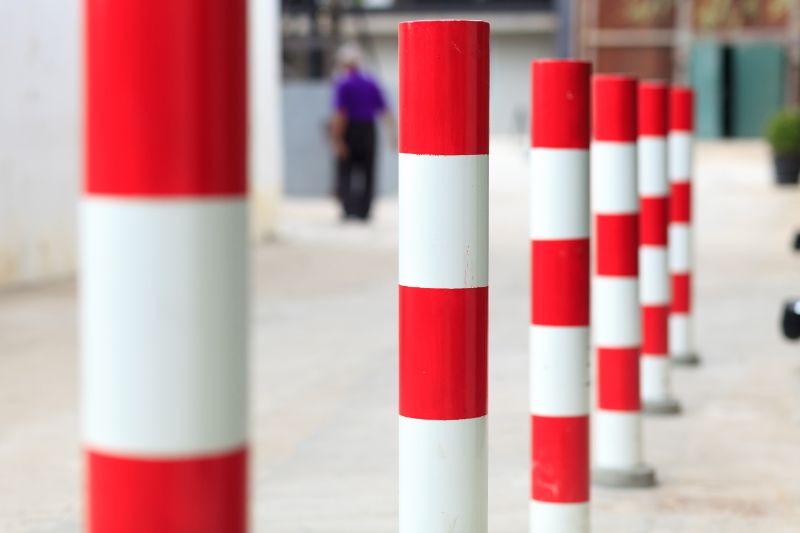 safe security bollards Can Bollards Really Keep People Safe? 1 A line of red and white striped security bollards
