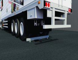Truck tires against a gray wheel stop in a parking lot, showing how wheel stops are used to prevent vehicle overruns.
